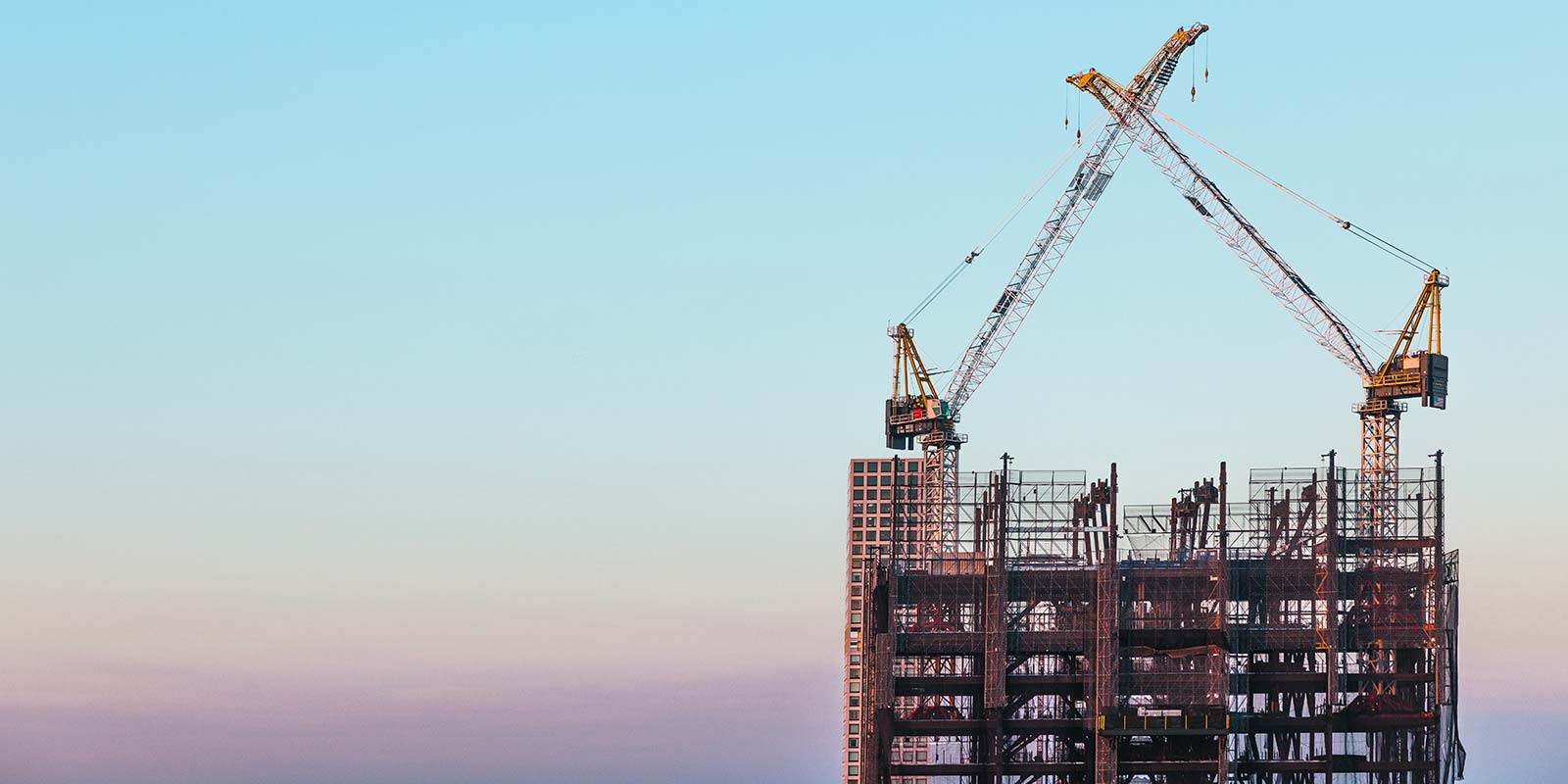 tall building with cranes